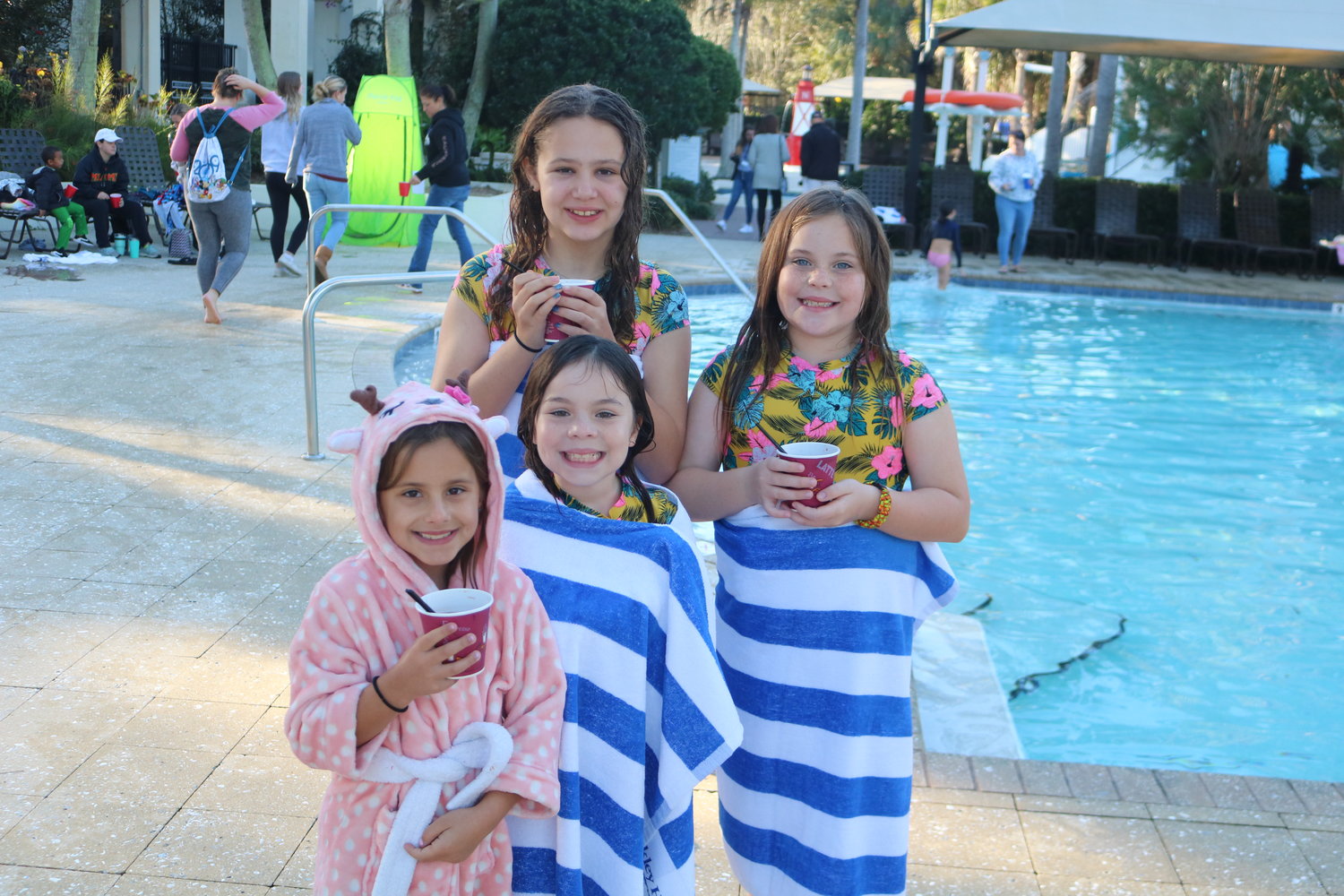 Leana Zunno, Abby Wagner, Avery Leyland and Sadie Wagner try to warm up after taking part in the Nocatee Polar Plunge.